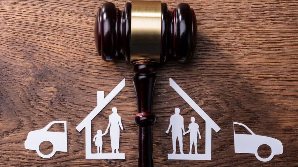 divorce lawyer image of gavel and home and car divided